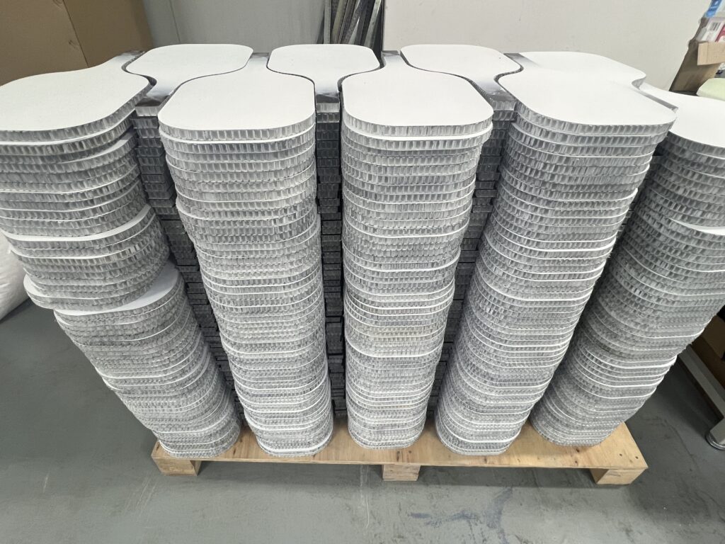 Thermoformed carbon fiber pickleball paddles in bulk production inside a professional paddle manufacturing factory