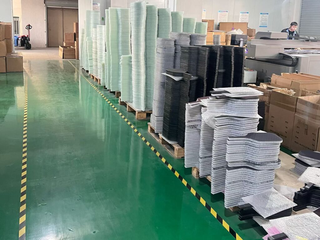 Pickleball paddle printing workshop with stacked paddle cores and workers operating printing machines for customized paddle design